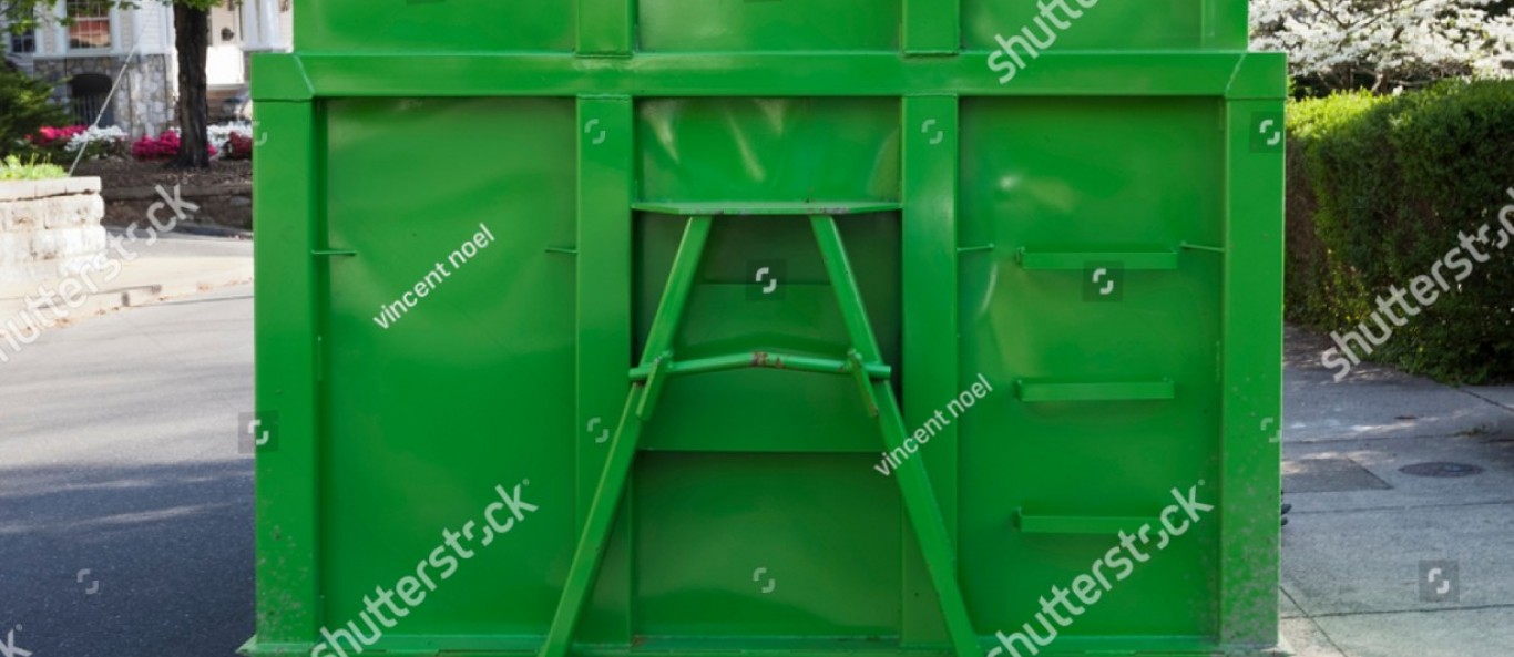 stock photo newly painted green industrial dumpster container on neighborhood street isolated 1085429762 v2